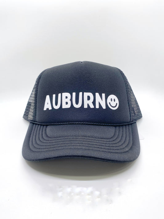 Show your Auburn, Alabama pride with this cute unisex trucker-style hat. The smiley face accent adds the perfect touch to show your love. After all, you are never fully dressed without a smile.   100% Cotton, Adjustable Back