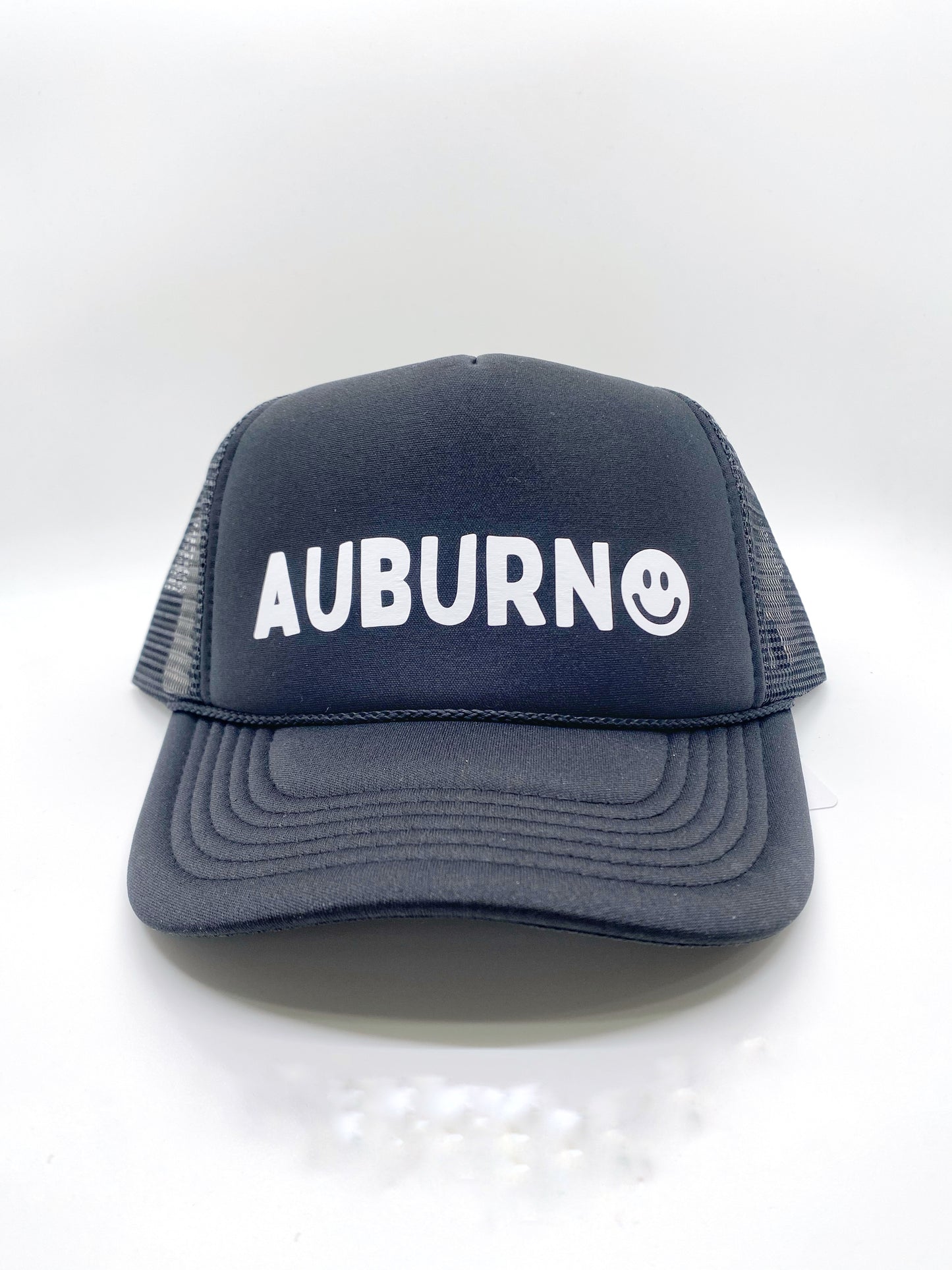 Show your Auburn, Alabama pride with this cute unisex trucker-style hat. The smiley face accent adds the perfect touch to show your love. After all, you are never fully dressed without a smile.   100% Cotton, Adjustable Back
