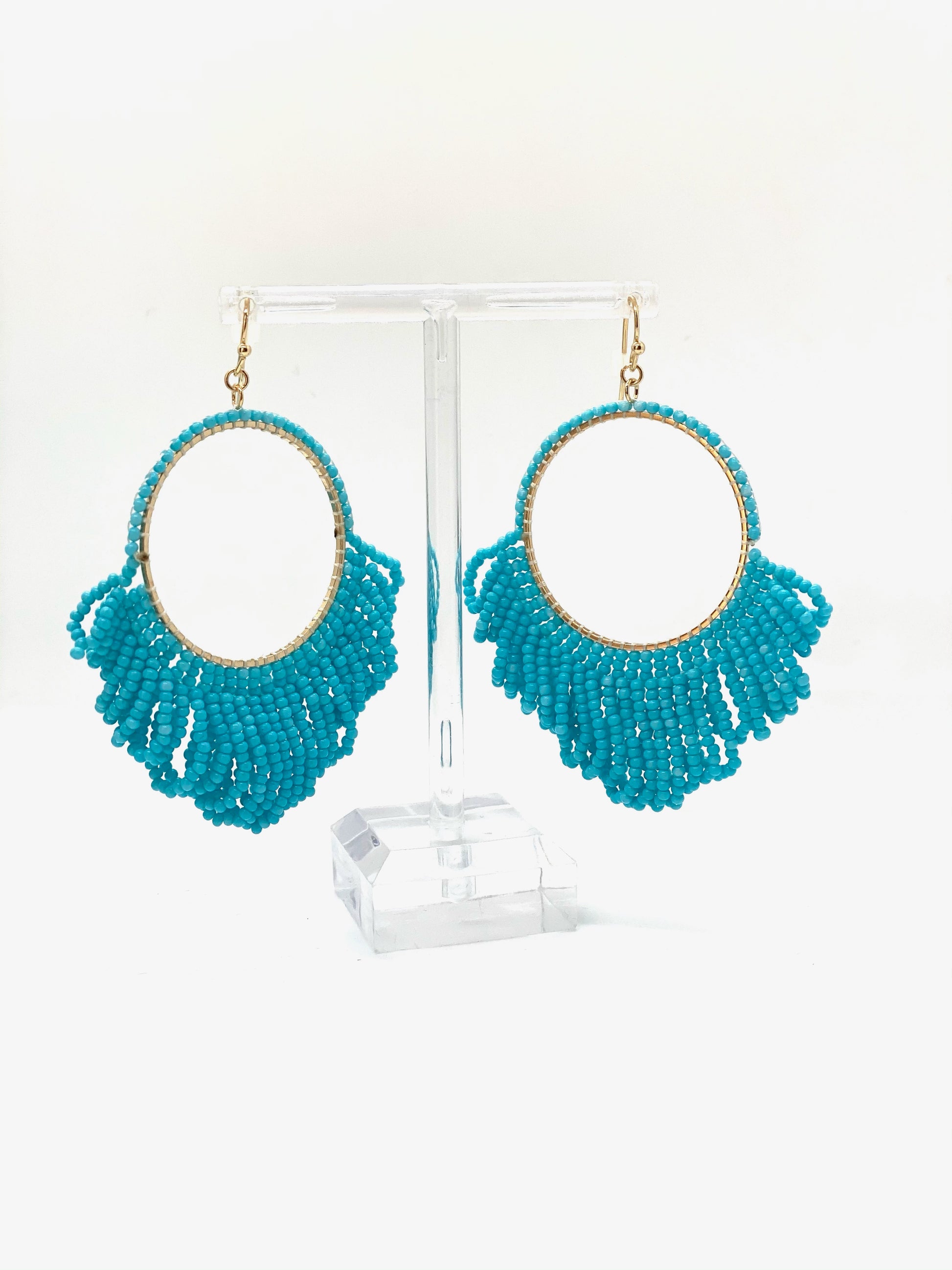 Add some fringe to your favorite outfit with these fun fringe beaded earrings! These earrings feature a gold hardware finish and a fish hook wire closure. Comes in Black or Teal.